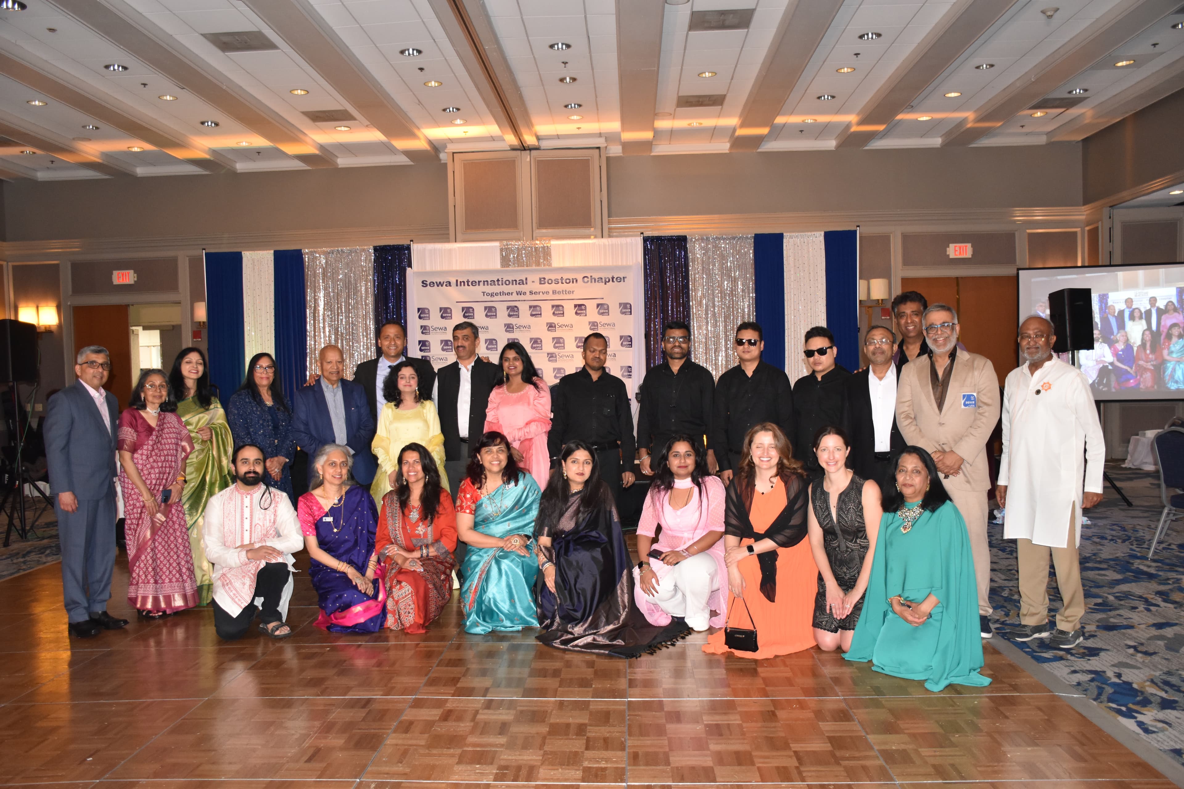 A group of people with disabilities smiling and looking at the camera.